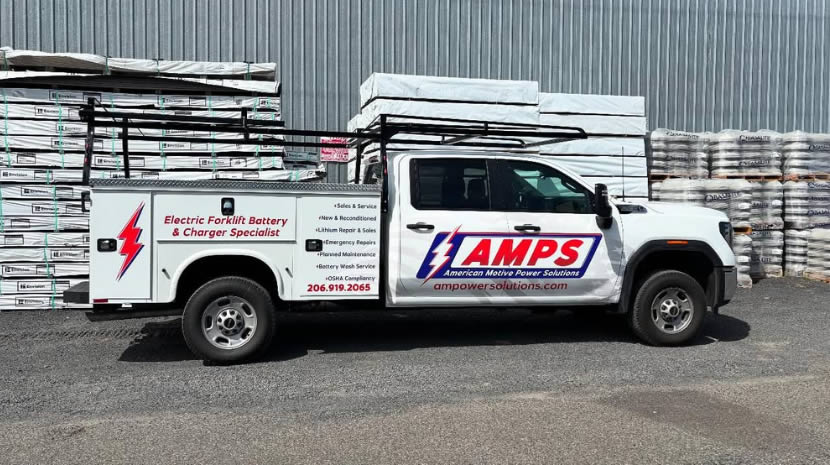 AMPS work truck a white truck with a black rack on top of it